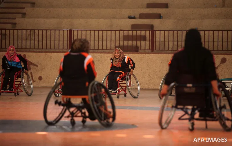 Disabled Palestinians take part in a training course to play basketball organised by the Palestinian Red Cross, in Khan Younis in the southern Gaza strip, on May 28, 2016. Photo by Ashraf Amra