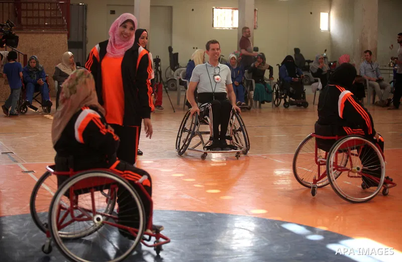 An American coach Jess marc, trains disabled Palestinians to play a basketball during a training course organised by the Palestinian Red Cross, in Khan Younis in the southern Gaza strip, on May 28, 2016. Photo by Ashraf...
