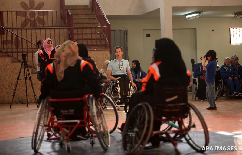 An American coach Jess marc, trains disabled Palestinians to play a basketball during a training course organised by the Palestinian Red Cross, in Khan Younis in the southern Gaza strip, on May 28, 2016. Photo by Ashraf...