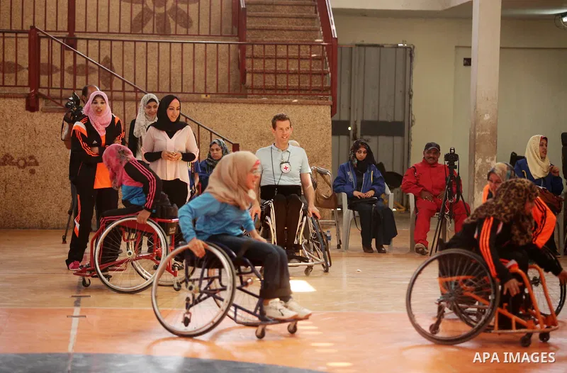 An American coach Jess marc, trains disabled Palestinians to play a basketball during a training course organised by the Palestinian Red Cross, in Khan Younis in the southern Gaza strip, on May 28, 2016. Photo by Ashraf...