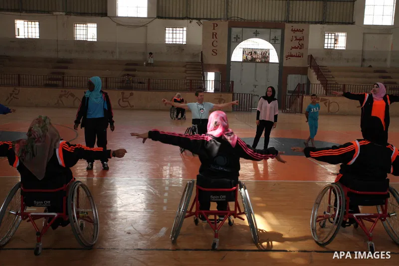 An American coach Jess marc, trains disabled Palestinians to play a basketball during a training course organised by the Palestinian Red Cross, in Khan Younis in the southern Gaza strip, on May 28, 2016. Photo by Ashraf...