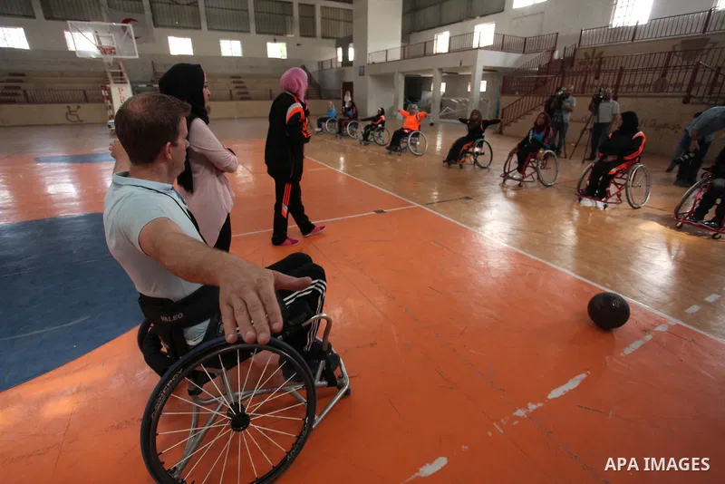 An American coach Jess marc, trains disabled Palestinians to play a basketball during a training course organised by the Palestinian Red Cross, in Khan Younis in the southern Gaza strip, on May 28, 2016. Photo by Ashraf...