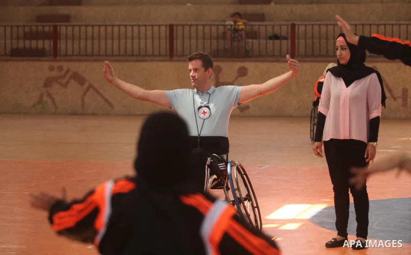 An American coach Jess marc, trains disabled Palestinians to play a basketball during a training course organised by the Palestinian Red Cross, in Khan Younis in the southern Gaza strip, on May 28, 2016. Photo by Ashraf...