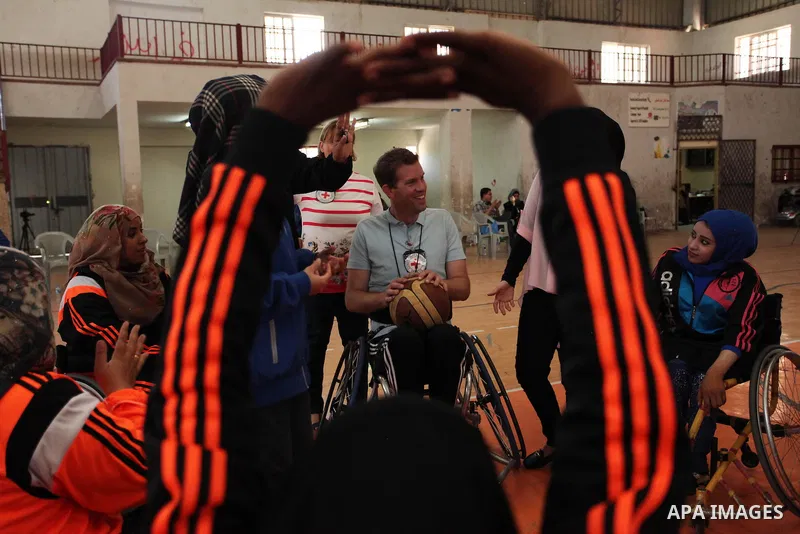 An American coach Jess marc, trains disabled Palestinians to play a basketball during a training course organised by the Palestinian Red Cross, in Khan Younis in the southern Gaza strip, on May 28, 2016. Photo by Ashraf...
