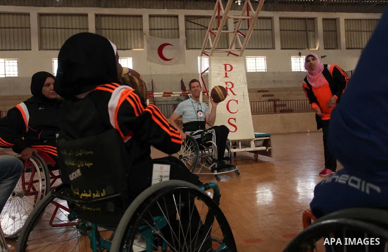 An American coach Jess marc, trains disabled Palestinians to play a basketball during a training course organised by the Palestinian Red Cross, in Khan Younis in the southern Gaza strip, on May 28, 2016. Photo by Ashraf...