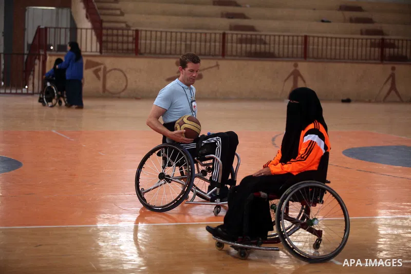 An American coach Jess marc, trains disabled Palestinians to play a basketball during a training course organised by the Palestinian Red Cross, in Khan Younis in the southern Gaza strip, on May 28, 2016. Photo by Ashraf...
