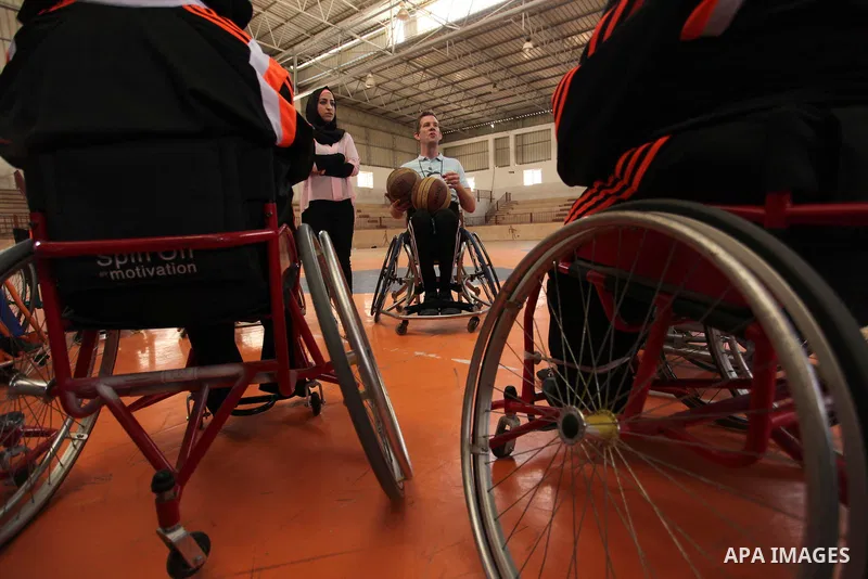 An American coach Jess marc, trains disabled Palestinians to play a basketball during a training course organised by the Palestinian Red Cross, in Khan Younis in the southern Gaza strip, on May 28, 2016. Photo by Ashraf...