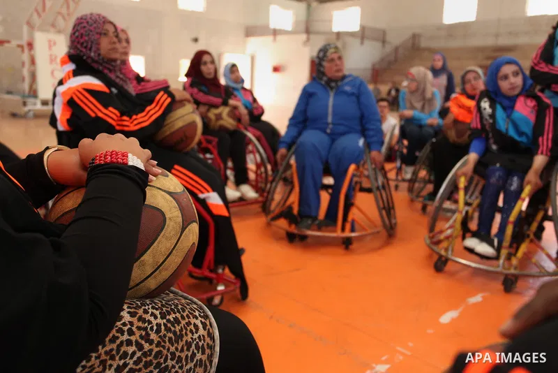 An American coach Jess marc, trains disabled Palestinians to play a basketball during a training course organised by the Palestinian Red Cross, in Khan Younis in the southern Gaza strip, on May 28, 2016. Photo by Ashraf...