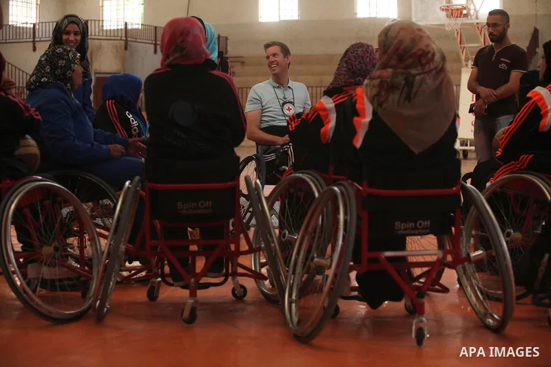 An American coach Jess marc, trains disabled Palestinians to play a basketball during a training course organised by the Palestinian Red Cross, in Khan Younis in the southern Gaza strip, on May 28, 2016. Photo by Ashraf...