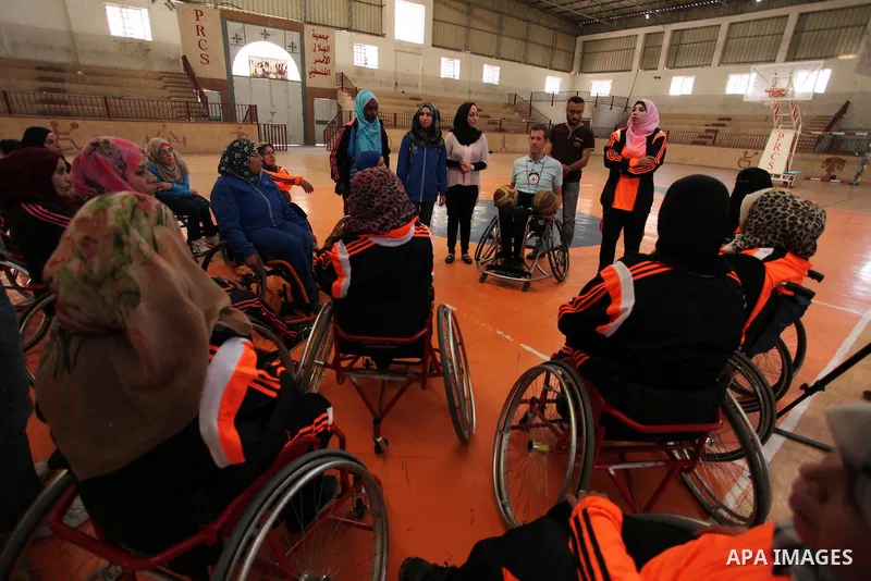 An American coach Jess marc, trains disabled Palestinians to play a basketball during a training course organised by the Palestinian Red Cross, in Khan Younis in the southern Gaza strip, on May 28, 2016. Photo by Ashraf...