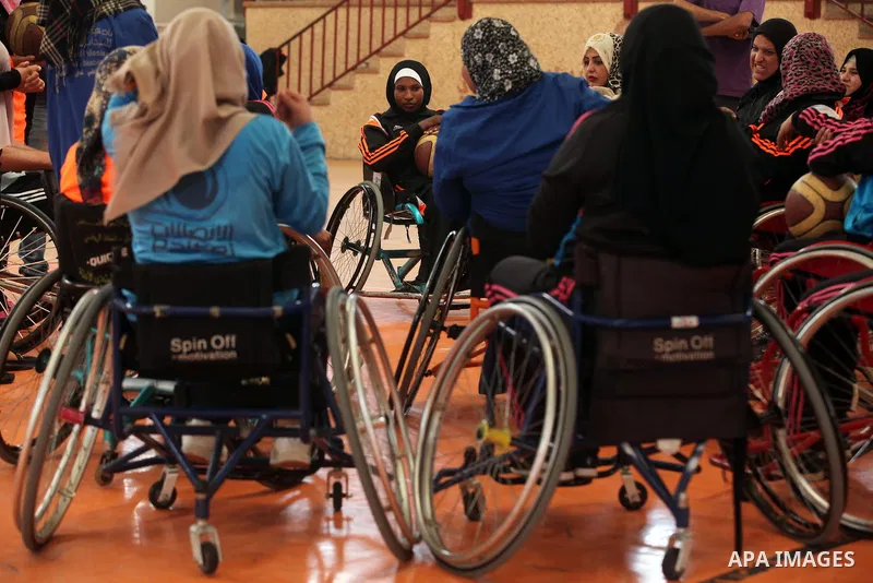 An American coach Jess marc, trains disabled Palestinians to play a basketball during a training course organised by the Palestinian Red Cross, in Khan Younis in the southern Gaza strip, on May 28, 2016. Photo by Ashraf...