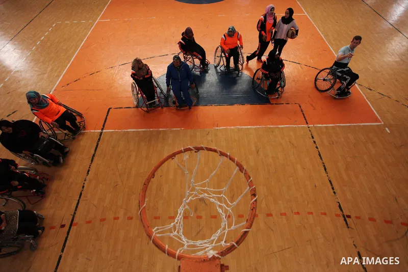 Disabled Palestinians take part in a training course to play basketball organised by the Palestinian Red Cross in Khan Younis in the southern Gaza strip, on May 28, 2016. Photo by Ashraf Amra