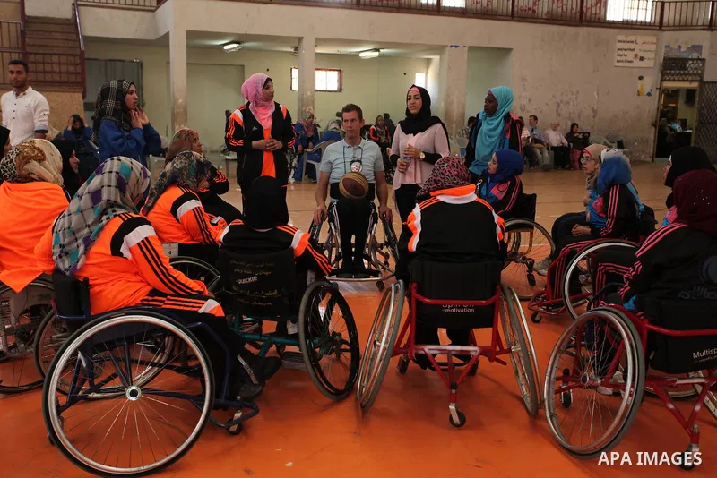 An American coach Jess marc, trains disabled Palestinians to play a basketball during a training course organised by the Palestinian Red Cross, in Khan Younis in the southern Gaza strip, on May 28, 2016. Photo by Ashraf...