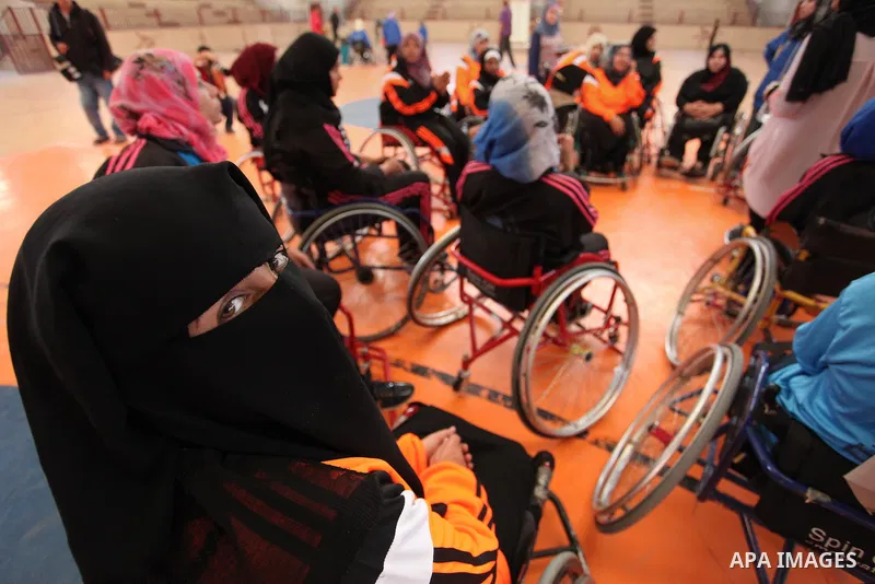 An American coach Jess marc, trains disabled Palestinians to play a basketball during a training course organised by the Palestinian Red Cross, in Khan Younis in the southern Gaza strip, on May 28, 2016. Photo by Ashraf...