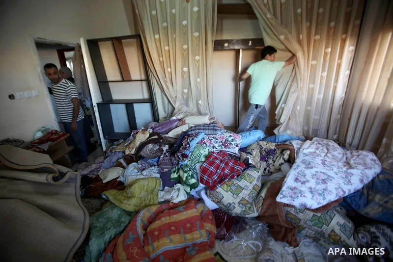 Palestinians inspect their room after the Israeli soldiers raided their family house, at Salem village near the West Bank city of Nablus, on May 30, 2016. Photo by Nedal Eshtayah