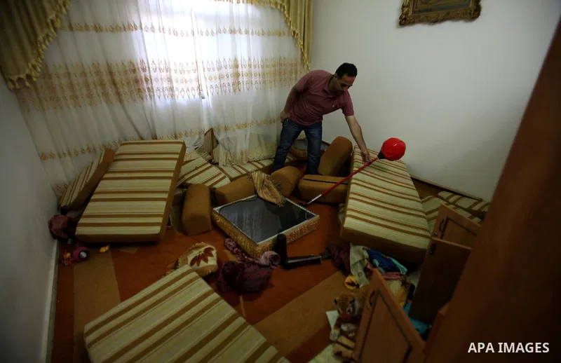 Palestinians inspect their room after the Israeli soldiers raided their family house, at Salem village near the West Bank city of Nablus, on May 30, 2016. Photo by Nedal Eshtayah