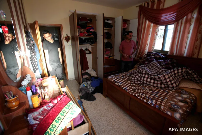 Palestinians inspect their room after the Israeli soldiers raided their family house, at Salem village near the West Bank city of Nablus, on May 30, 2016. Photo by Nedal Eshtayah
