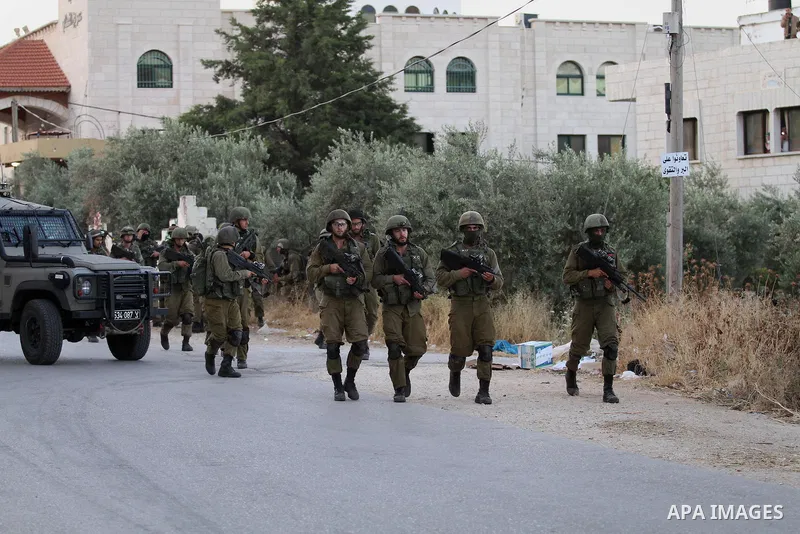 Israeli soldiers patrol a street, at Salem village near the West Bank city of Nablus, on May 30, 2016. Photo by Nedal Eshtayah