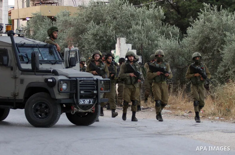 Israeli soldiers patrol a street, at Salem village near the West Bank city of Nablus, on May 30, 2016. Photo by Nedal Eshtayah