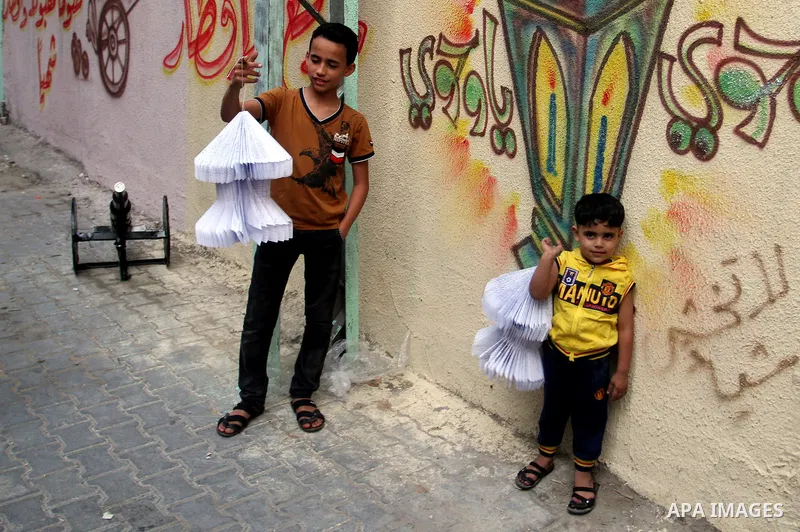 A Palestinian boy holds a traditional lanterns known in Arabic as "Fanous" that are used during the holy month of Ramadan in the Rafah refugee camp in southern Gaza Strip on May 30, 2016. Photo by Abed Rahim Khatib