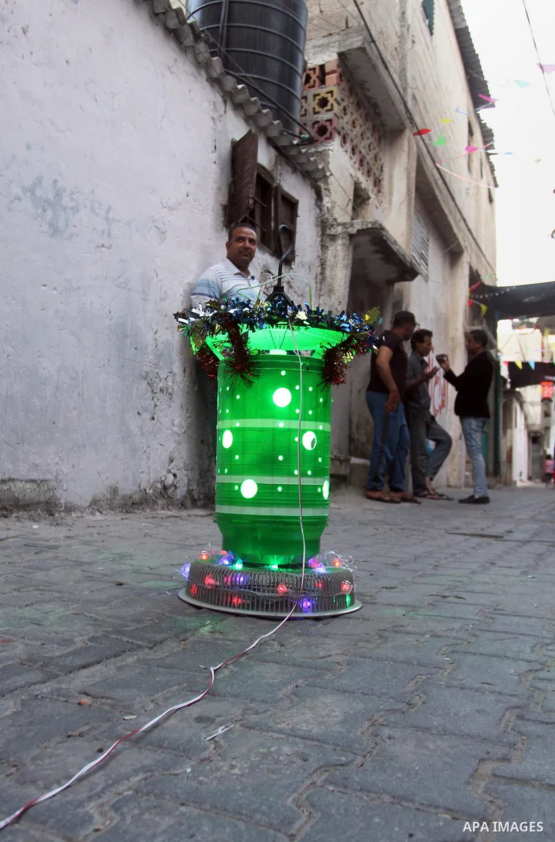 A Palestinian boy holds a traditional lanterns known in Arabic as "Fanous" that are used during the holy month of Ramadan in the Rafah refugee camp in southern Gaza Strip on May 30, 2016. Photo by Abed Rahim Khatib