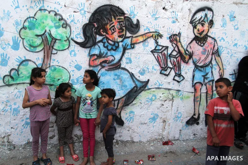 Palestinian children stand outside their house during hang up decorations before the holy month of Ramadan in the Rafah refugee camp in southern Gaza Strip on May 30, 2016. Photo by Abed Rahim Khatib