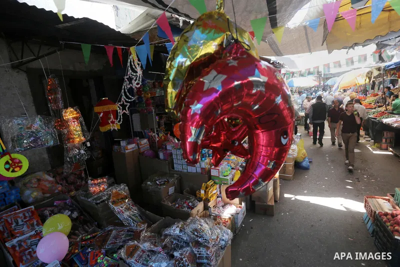 A Palestinian vendor displays a traditional lantern known in Arabic as "Fanous" and toys in a market in Gaza city as the faithful prepare for the start of the Muslim holy fasting month of Ramadan on May 31, 2016. More th...