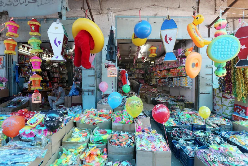 A Palestinian vendor displays a traditional lantern known in Arabic as "Fanous" and toys in a market in Gaza city as the faithful prepare for the start of the Muslim holy fasting month of Ramadan on May 31, 2016. More th...