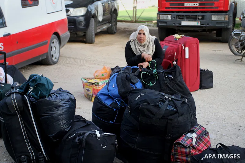 Palestinians wait for travel permits to cross into Egypt through the Rafah border crossing after it was opened for four days by Egyptian authorities, in the southern Gaza Strip June 1, 2016. Photo by Abed Rahim Khatib