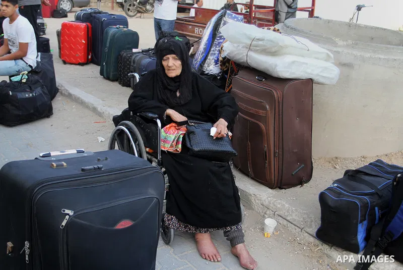 Palestinians wait for travel permits to cross into Egypt through the Rafah border crossing after it was opened for four days by Egyptian authorities, in the southern Gaza Strip June 1, 2016. Photo by Abed Rahim Khatib