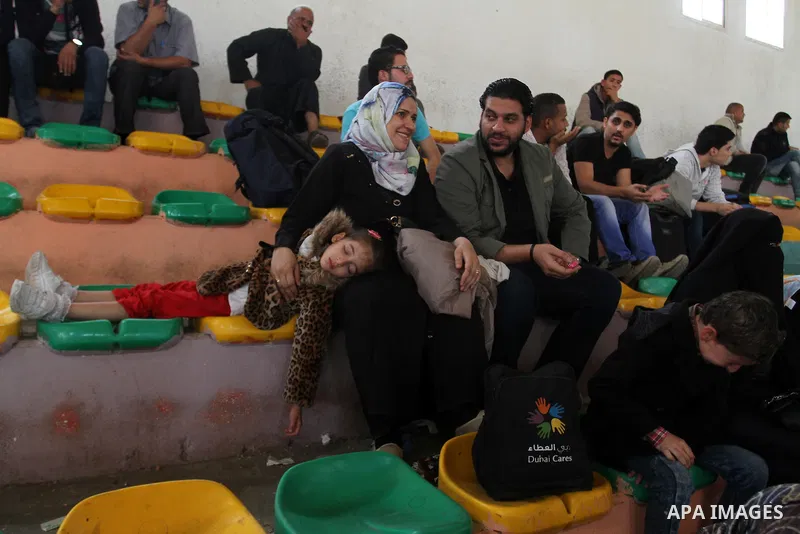 Palestinians wait for travel permits to cross into Egypt through the Rafah border crossing after it was opened for four days by Egyptian authorities, in the southern Gaza Strip June 1, 2016. Photo by Abed Rahim Khatib
