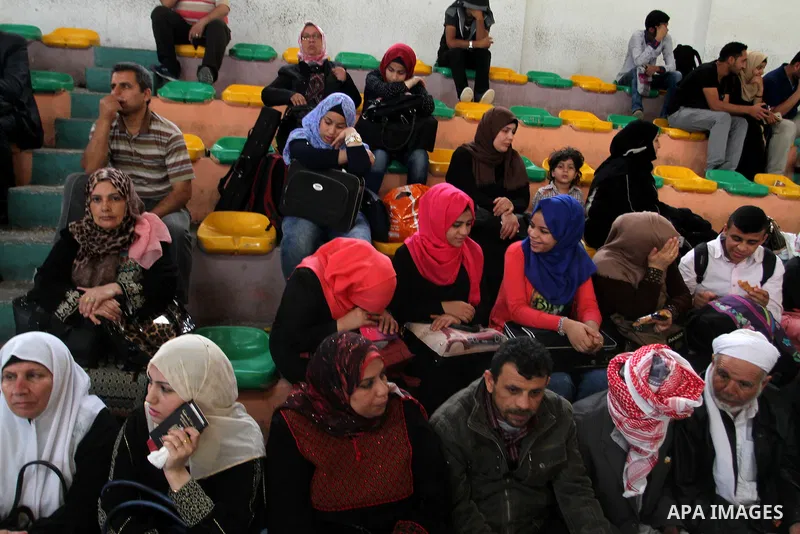 Palestinians wait for travel permits to cross into Egypt through the Rafah border crossing after it was opened for four days by Egyptian authorities, in the southern Gaza Strip June 1, 2016. Photo by Abed Rahim Khatib