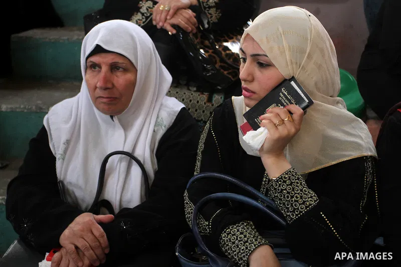 Palestinians wait for travel permits to cross into Egypt through the Rafah border crossing after it was opened for four days by Egyptian authorities, in the southern Gaza Strip June 1, 2016. Photo by Abed Rahim Khatib