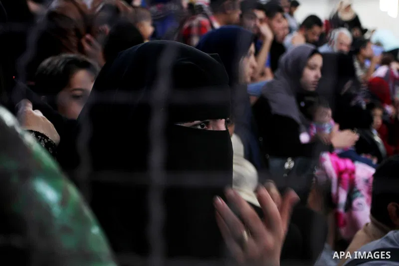 Palestinians wait for travel permits to cross into Egypt through the Rafah border crossing after it was opened for four days by Egyptian authorities, in the southern Gaza Strip June 1, 2016. Photo by Abed Rahim Khatib