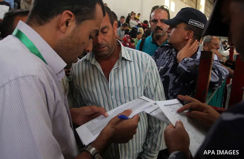 Palestinians wait for travel permits to cross into Egypt through the Rafah border crossing after it was opened for four days by Egyptian authorities, in the southern Gaza Strip June 1, 2016. Photo by Abed Rahim Khatib