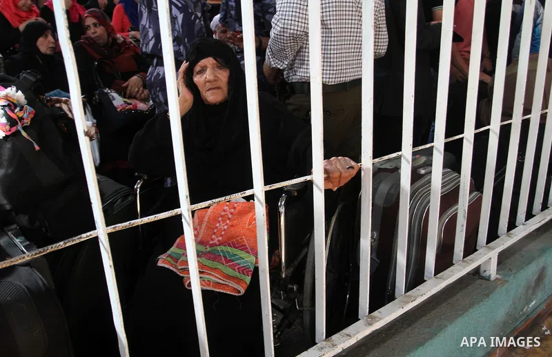 Palestinians wait for travel permits to cross into Egypt through the Rafah border crossing after it was opened for four days by Egyptian authorities, in the southern Gaza Strip June 1, 2016. Photo by Abed Rahim Khatib