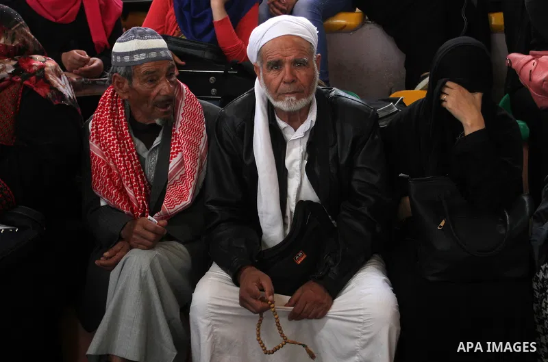 Palestinians wait for travel permits to cross into Egypt through the Rafah border crossing after it was opened for four days by Egyptian authorities, in the southern Gaza Strip June 1, 2016. Photo by Abed Rahim Khatib
