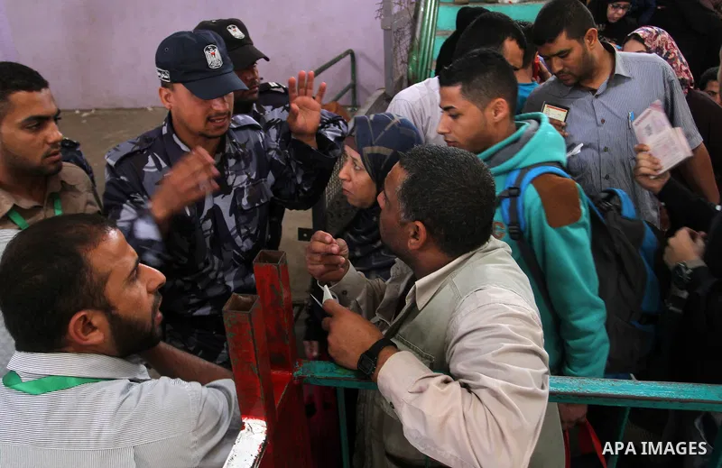 Palestinians wait for travel permits to cross into Egypt through the Rafah border crossing after it was opened for four days by Egyptian authorities, in the southern Gaza Strip June 1, 2016. Photo by Abed Rahim Khatib