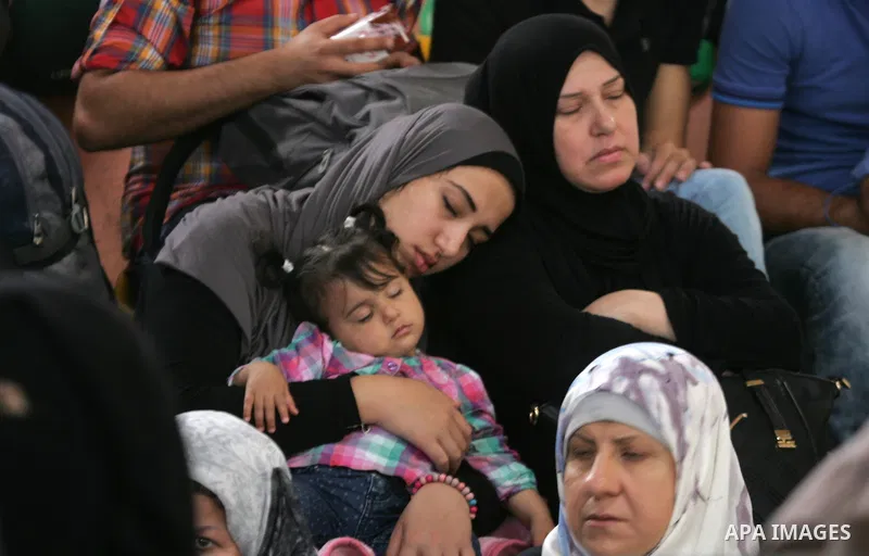 Palestinians wait for travel permits to cross into Egypt through the Rafah border crossing after it was opened for four days by Egyptian authorities, in the southern Gaza Strip June 1, 2016. Photo by Abed Rahim Khatib