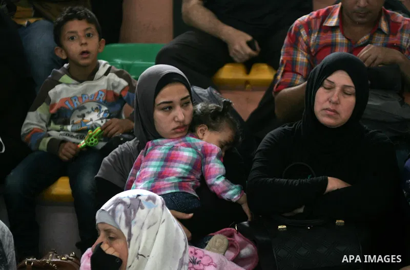 Palestinians wait for travel permits to cross into Egypt through the Rafah border crossing after it was opened for four days by Egyptian authorities, in the southern Gaza Strip June 1, 2016. Photo by Abed Rahim Khatib