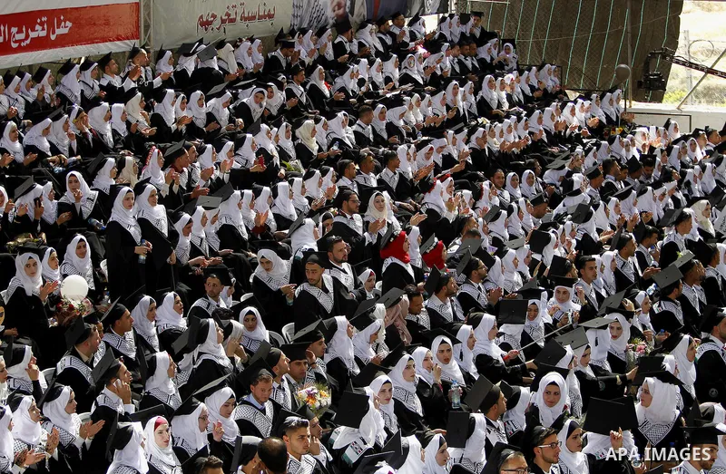 Palestinian students attend their graduation ceremony at the end of the academic year on June 01, 2016 at Hebron University in the West Bank city of Hebron. Photo by Wisam Hashlamoun