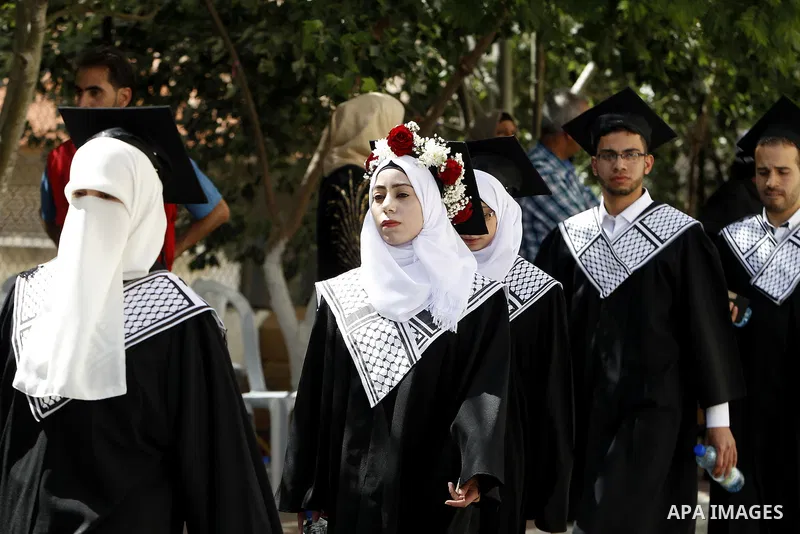 Palestinian students attend their graduation ceremony at the end of the academic year on June 01, 2016 at Hebron University in the West Bank city of Hebron. Photo by Wisam Hashlamoun