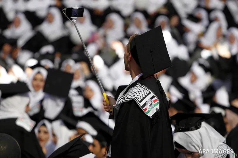 Palestinian students attend their graduation ceremony at the end of the academic year on June 01, 2016 at Hebron University in the West Bank city of Hebron. Photo by Wisam Hashlamoun
