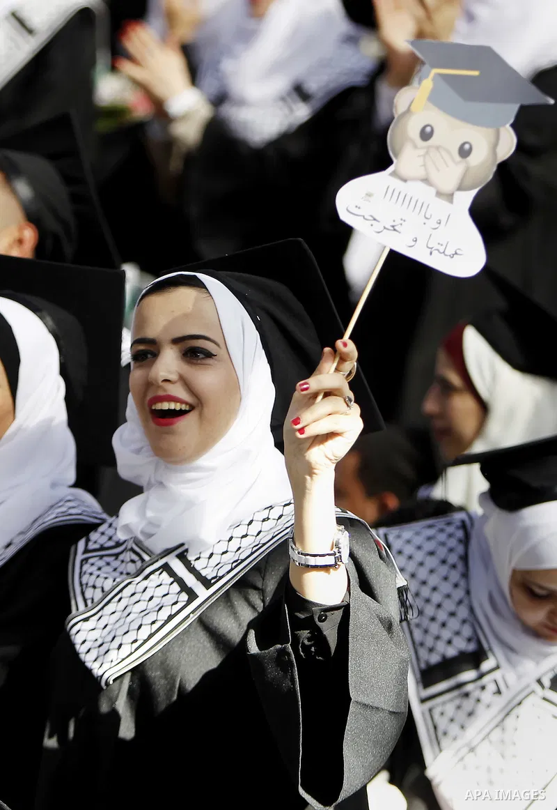 Palestinian students attend their graduation ceremony at the end of the academic year on June 01, 2016 at Hebron University in the West Bank city of Hebron. Photo by Wisam Hashlamoun