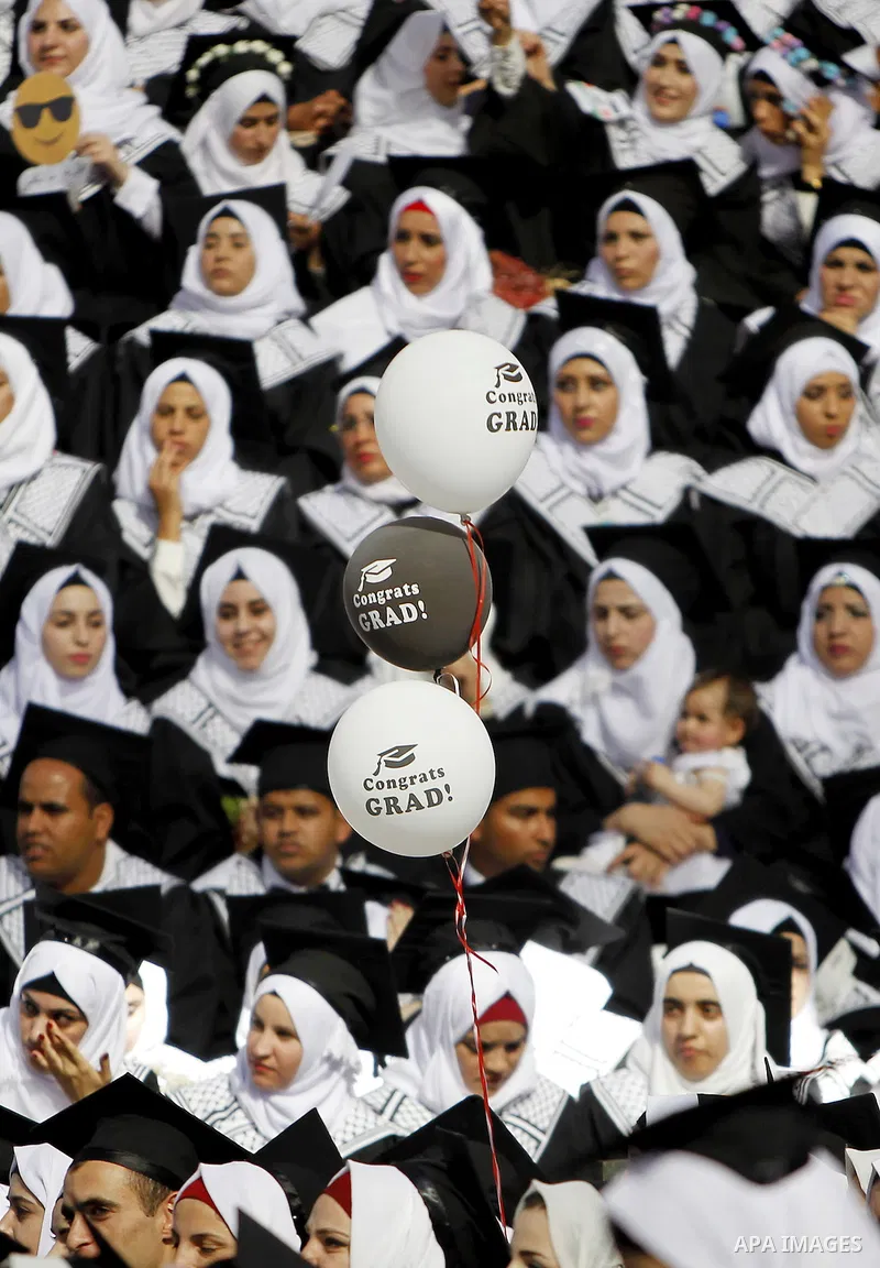 Palestinian students attend their graduation ceremony at the end of the academic year on June 01, 2016 at Hebron University in the West Bank city of Hebron. Photo by Wisam Hashlamoun