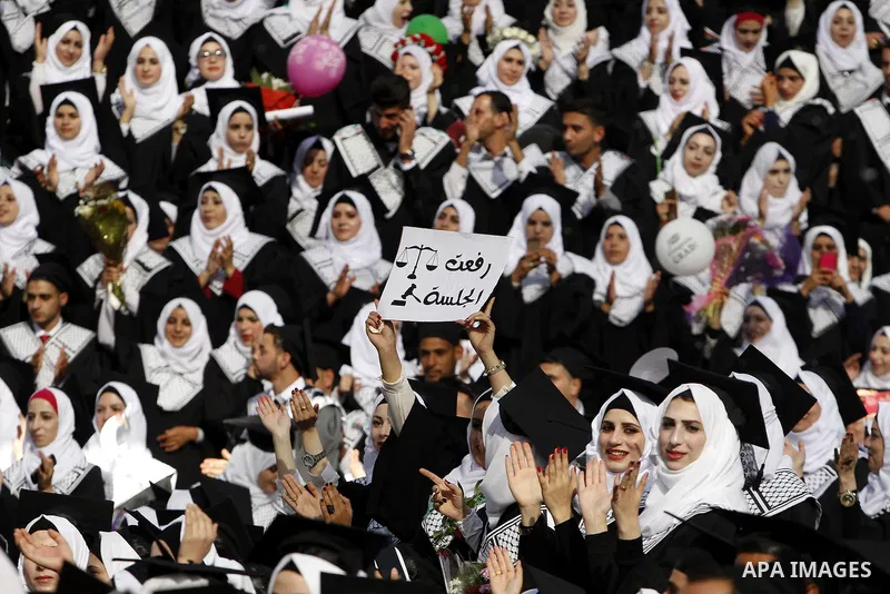 Palestinian students attend their graduation ceremony at the end of the academic year on June 01, 2016 at Hebron University in the West Bank city of Hebron. Photo by Wisam Hashlamoun