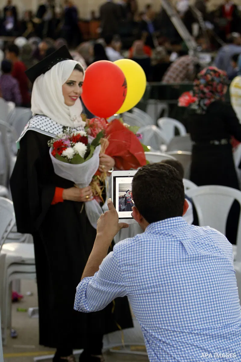 Palestinian students attend their graduation ceremony at the end of the academic year on June 01, 2016 at Hebron University in the West Bank city of Hebron. Photo by Wisam Hashlamoun