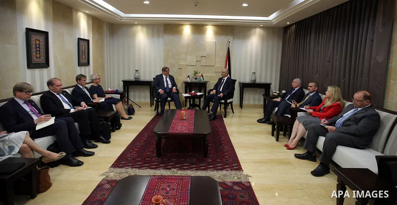 Palestinian Prime Minister Rami Hamdallah meets with a Finish Foreign Minister Timo Soini, in the West Bank city of Ramallah, on June 2, 2016. Photo by Prime Minister Office