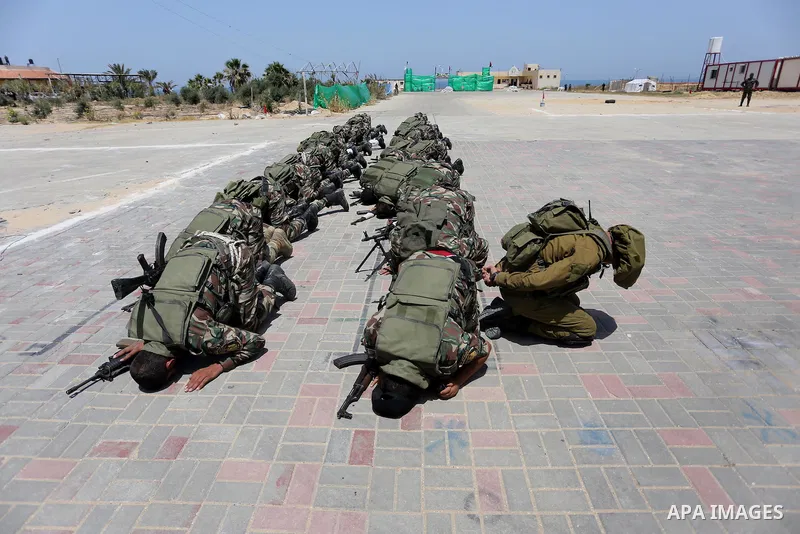 Member of Palestinian security forces display their skills during a military graduation ceremony in Gaza City June 2, 2016. Photo by Mohammed Asad