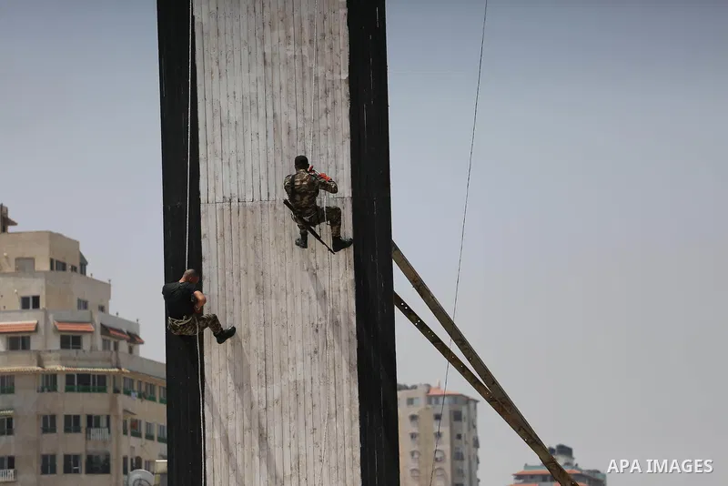 Member of Palestinian security forces display their skills during a military graduation ceremony in Gaza City June 2, 2016. Photo by Mohammed Asad